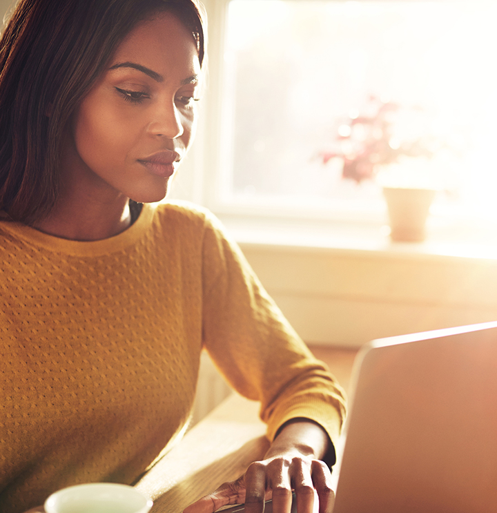 woman reading root cause guide on a laptop